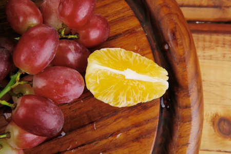 fresh raw red grape on wooden tableの写真素材