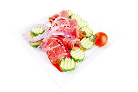 fresh red barbecue meat bacon served on plate with vegetables isolated on white backgroundの写真素材