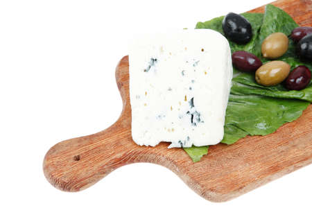 stilton cheese on wooden platter with olives and tomato isolated over white backgroundの写真素材