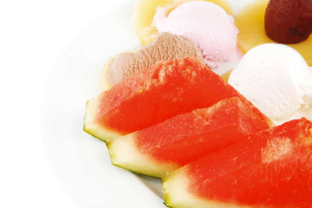 watermelon plum and slice of pineapple and chocolate and fruit ice cream on white plate isolated over white backgroundの写真素材