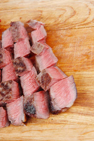 meat food : roast beef steak on wood plate isolate on white backgroundの写真素材