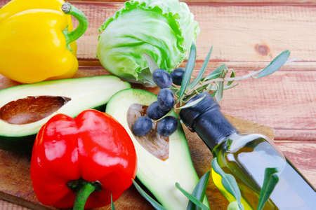 fresh raw vegetables prepared for cutting on woodの写真素材