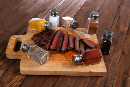 fresh roast red beef meat fillet mignon cutted on wooden plateの写真素材