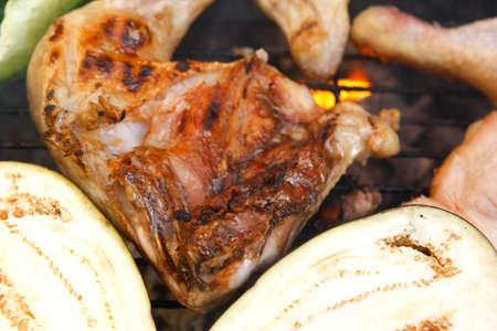 fresh grilled and raw chicken thighs with green orange yellow pepper bell slice on hot grill bbq
