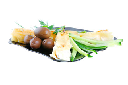 cheese cannelloni served with vegetables on black plate