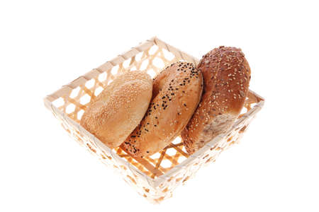 three different bagels in basket isolated over white backgroundの写真素材