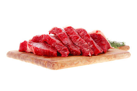fresh raw beef meat steak slices on wooden cut board isolated over white backgroundの写真素材