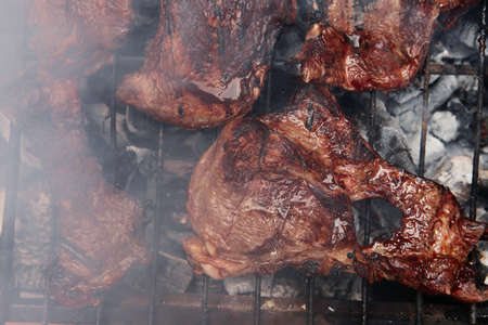fresh hot bbq grill red beef meat steak ready on grid over charcoal with marksの写真素材