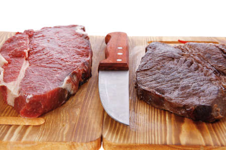 grilled and raw beef steak fillet meat with knife on wooden board isolated over white background