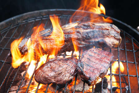 fresh red grilled beef meat fillet asado on deep round bbq grill over fire