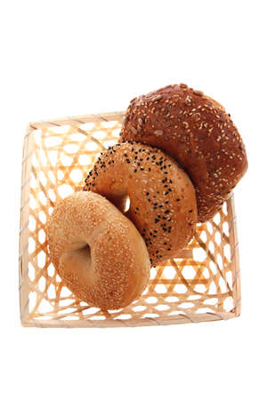 three different bagels in basket isolated over white backgroundの写真素材