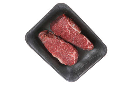 two fresh raw marble beef meat sirloin porterhouse steak on black market plastic tray isolated on white backgroundの写真素材