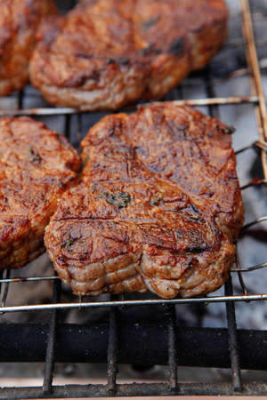 fresh beef meat fillet steak on barbecue grill grid cooked over burned charcoal readyの写真素材