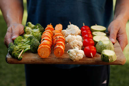 fresh raw vegetable kebab on bbq grid cooked over hot burned charcoalの写真素材