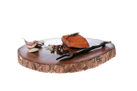 breakfast delicious portion of fresh roast salmon fillet with dry spices garlic and rosemary on wooden plate with black forged handmade fork healthy food diet cooking concept isolated on white background empty spaceの写真素材