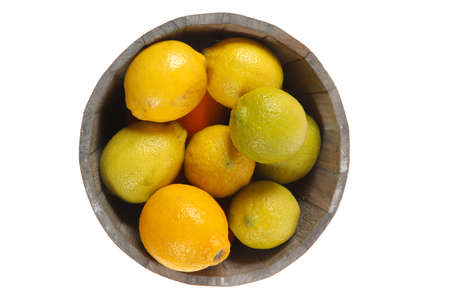 harvest of fresh raw lemon in wooden bucket isolated over white backgroundの写真素材