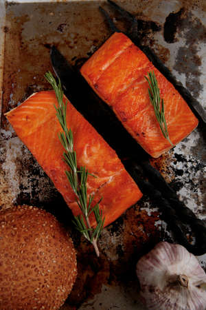 delicious portion of raw fresh salmon fillet with aromatic herbs and spices on vintage tray over wooden table - healthy food, diet cooking concept の写真素材