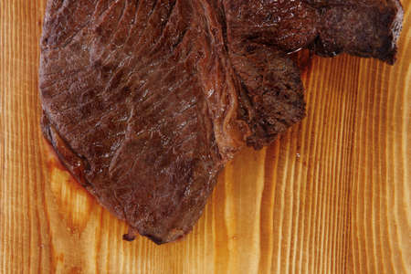 roast beefsteak fillet on wood isolated over white backgroundの写真素材