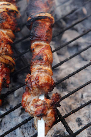 fresh beef meat kebab on barbecue grid grill cooked over burned churcoalの写真素材
