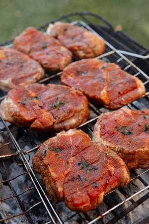 fresh beef meat fillet steak on barbecue grill grid cooked over burned charcoal readyの写真素材