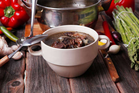 home style beef meat soup vintage country wood table asparagus pepper bell spices bread garlic...