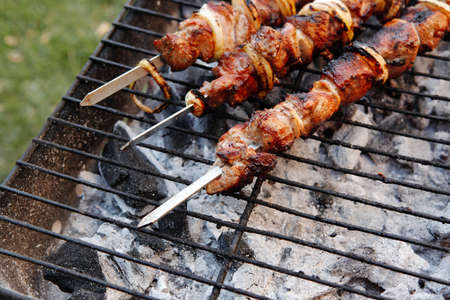 fresh beef meat kebab on barbecue grid grill cooked over burned churcoalの写真素材