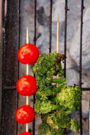 fresh raw vegetable kebab on bbq grid cooked over hot burned charcoalの写真素材