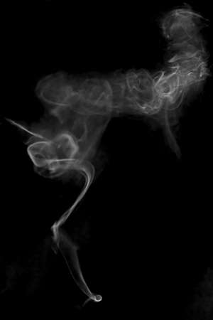 white textured smoke powder fluffy puffs explosion dust isolated on dark background as brushの写真素材