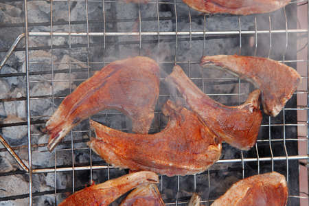 fresh raw lamb ribs on bbq grid grill cooked over charcoalの写真素材