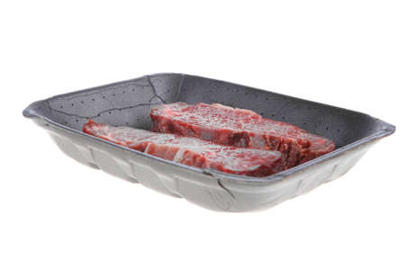 two fresh raw marble beef meat sirloin porterhouse steak on black market plastic tray isolated on white backgroundの写真素材
