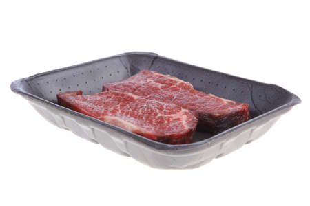 two fresh raw marble beef meat sirloin porterhouse steak on black market plastic tray isolated on white backgroundの写真素材
