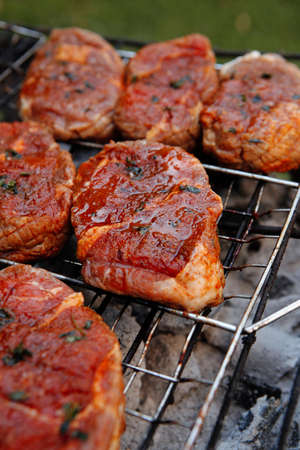 fresh beef meat fillet steak on barbecue grill grid cooked over burned charcoal readyの写真素材