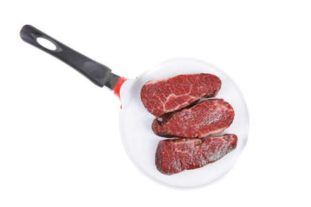 three fresh raw marble beef meat sirloin porterhouse steak on big ceramic cooking pan isolated on white backgroundの写真素材