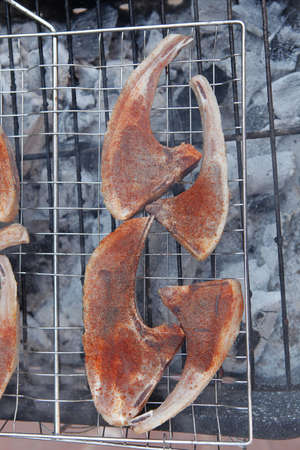 fresh raw lamb ribs on bbq grid grill cooked over charcoalの写真素材