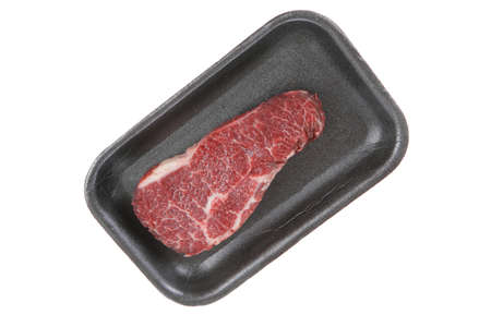 fresh raw marble beef meat steak on black plastic market tray isolated on white backgroundの写真素材