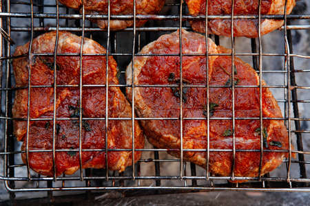 fresh beef meat fillet steak on barbecue grill grid cooked over burned charcoal readyの写真素材
