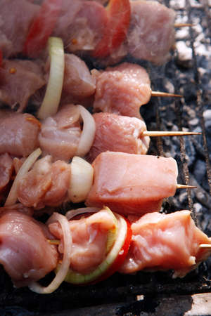 fresh raw turkey pork red meat fillet shish kebab on wooden skewers over vintage kind brazier full with ready charcoalの写真素材