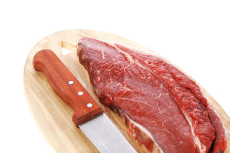 raw meat beefsteak fillet with knife on wood isolated over white backgroundの写真素材