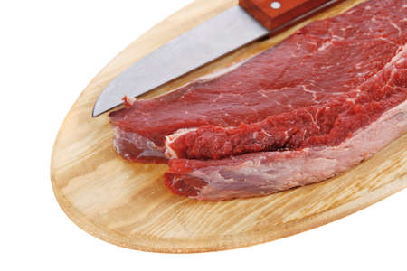 raw meat beefsteak fillet with knife on wood isolated over white backgroundの写真素材