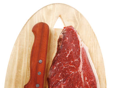 raw meat beefsteak fillet with knife on wood isolated over white backgroundの写真素材