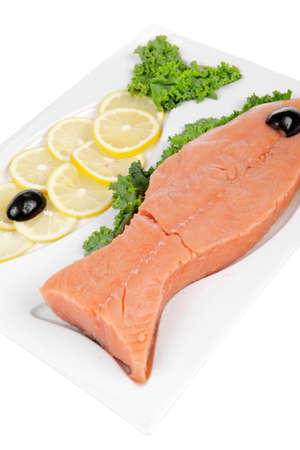 healthy food - fresh raw red fish with kale lemon and black olives on plate isolated on white background space for textの写真素材
