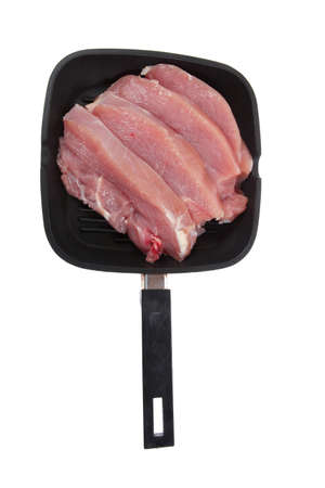 fresh raw turkey pieces on black pan isolated over white backgroundの写真素材