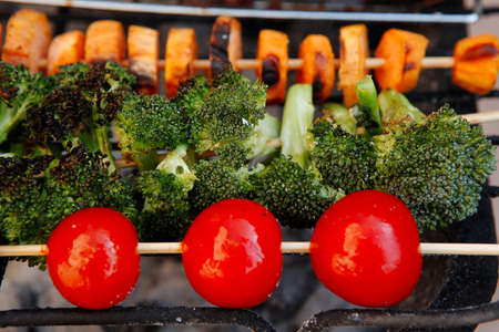 fresh raw vegetable kebab on bbq grid cooked over hot burned charcoalの写真素材