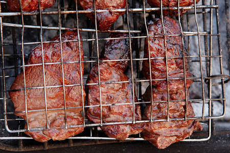 fresh beef meat fillet steak on barbecue grill grid cooked over burned charcoal readyの写真素材