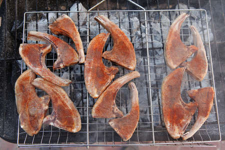 fresh raw lamb ribs on bbq grid grill cooked over charcoalの写真素材
