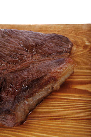 roast beefsteak fillet on wood isolated over white backgroundの写真素材