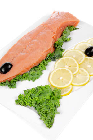 healthy food - fresh raw red fish with kale lemon and black olives on plate isolated on white background space for textの写真素材