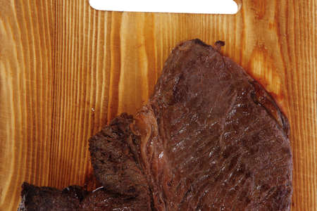 roast beefsteak fillet on wood isolated over white backgroundの写真素材