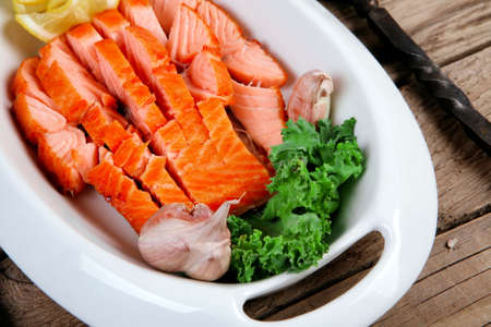 breakfast delicious portion of fresh roast salmon fillet with green chili sauce tomato soup dry spices over wooden table with black forged handmade cutlery - healthy food, diet cooking conceptの写真素材