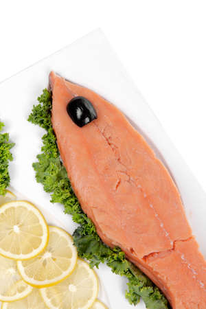 healthy food - fresh raw red fish with kale lemon and black olives on plate isolated on white background space for textの写真素材